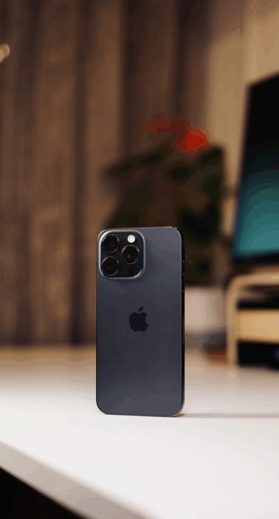 iPhone 15 Pro Max in blue titanium standing upright on white surface, one of the best camera for travel options and essential travel tech 2025 for content creators