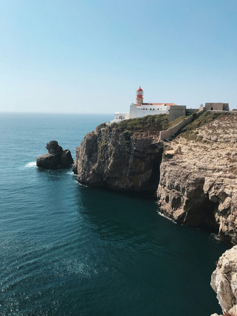 Lighthouse at Cabo de São Vicente on the Algarve coast, Portugal, overlooking dramatic cliffs and the Atlantic Ocean.
