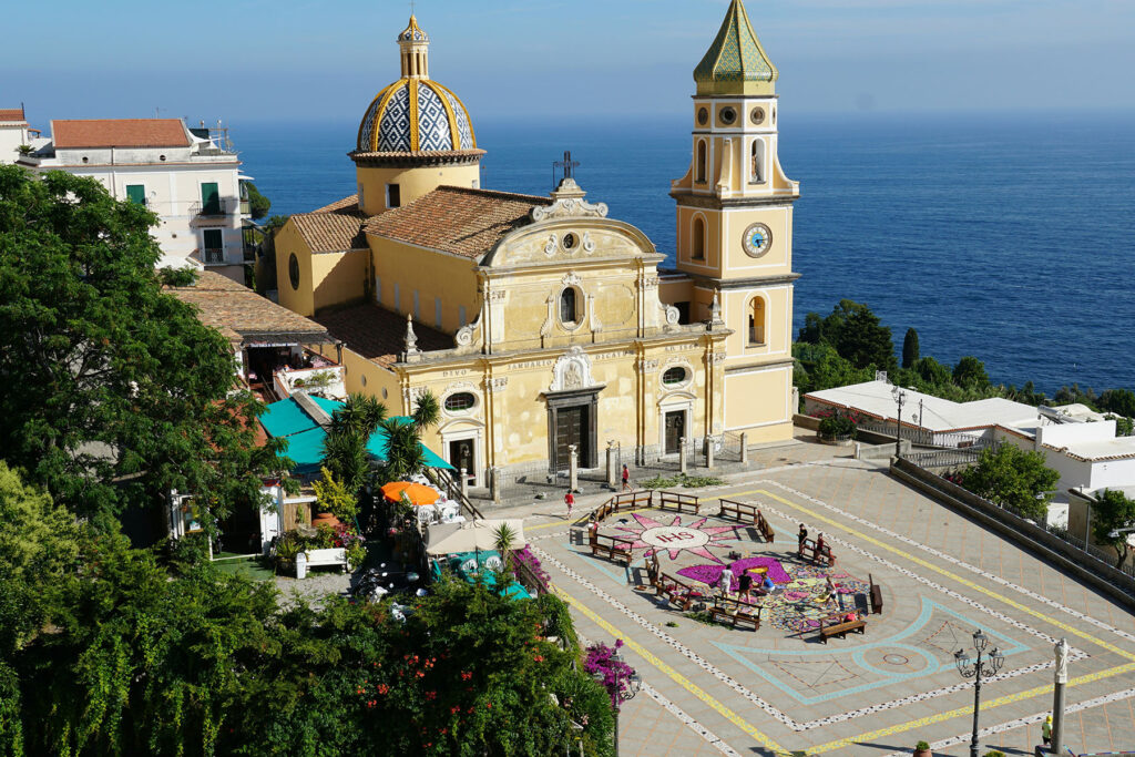 Church of San Gennaro in Praiano on the Amalfi Coast, with its colorful tiled dome and coastal views over the Mediterranean Sea.