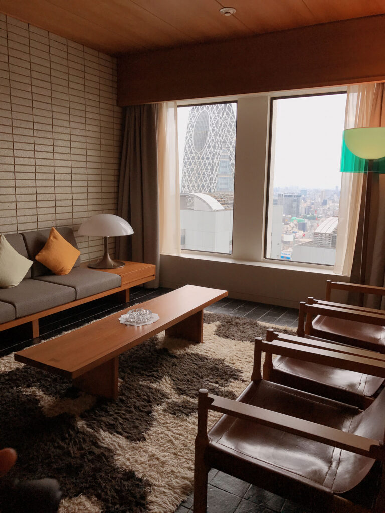 Modern lounge area inside Keio Plaza Hotel Tokyo Premier Grand with mid-century inspired furniture, warm wood interiors, and floor-to-ceiling windows overlooking the Tokyo skyline and Cocoon Tower. Nastasia Yakoub. All rights reserved. No reposts, reuse, or distribution without written permission.